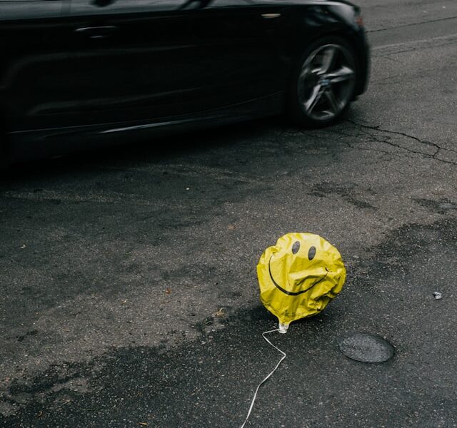 Photo of a deflated balloon with a smiley face on it