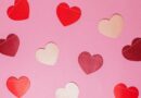 Image of paper hearts on a pink background