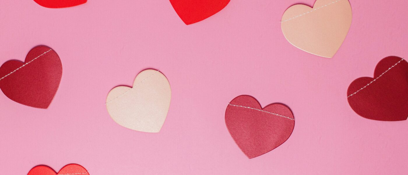 Image of paper hearts on a pink background