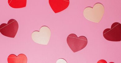 Image of paper hearts on a pink background